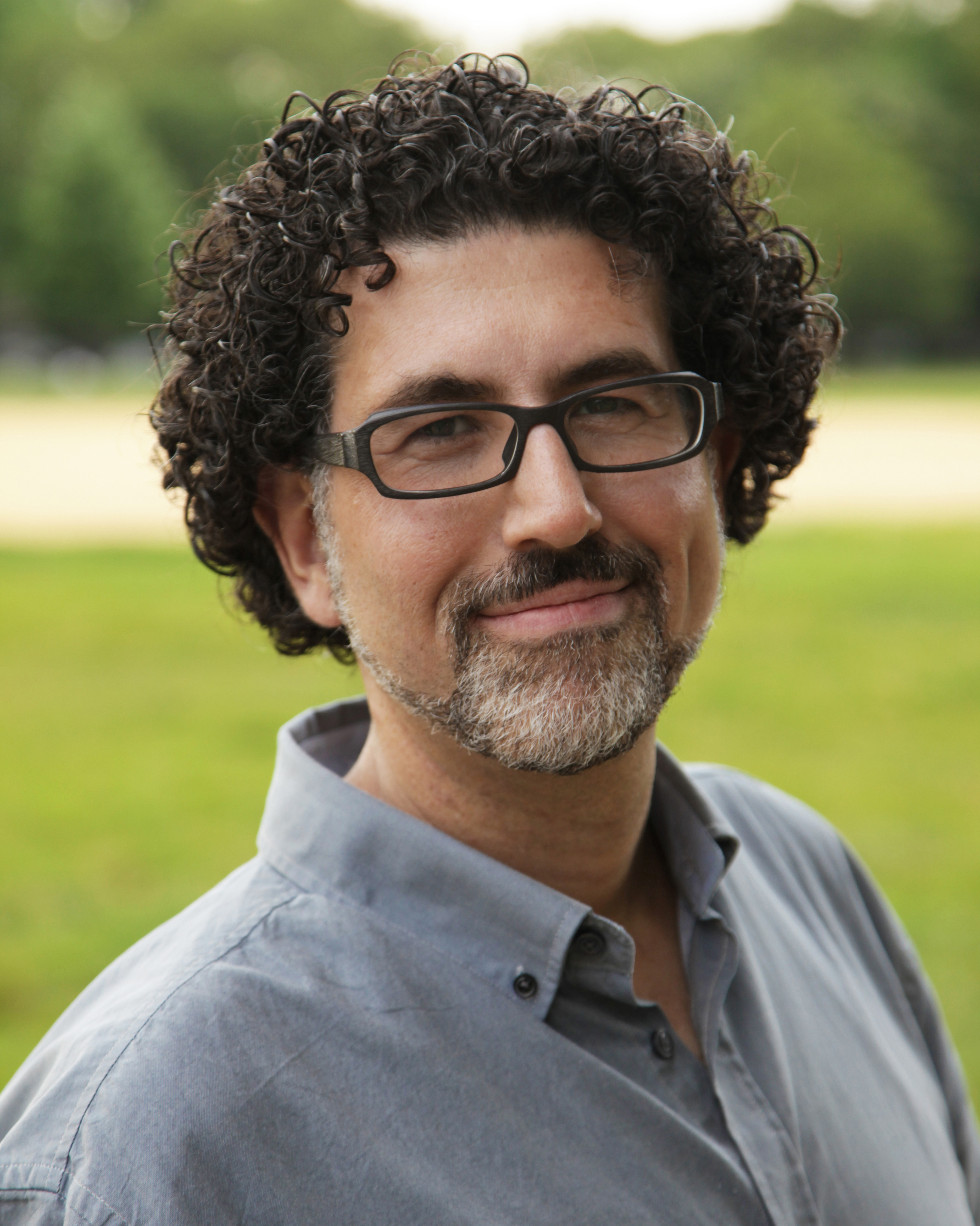 An outdoor photograph of Hrag Vartanian, Co-Founder and Editor-in-Chief of Hyperallergic