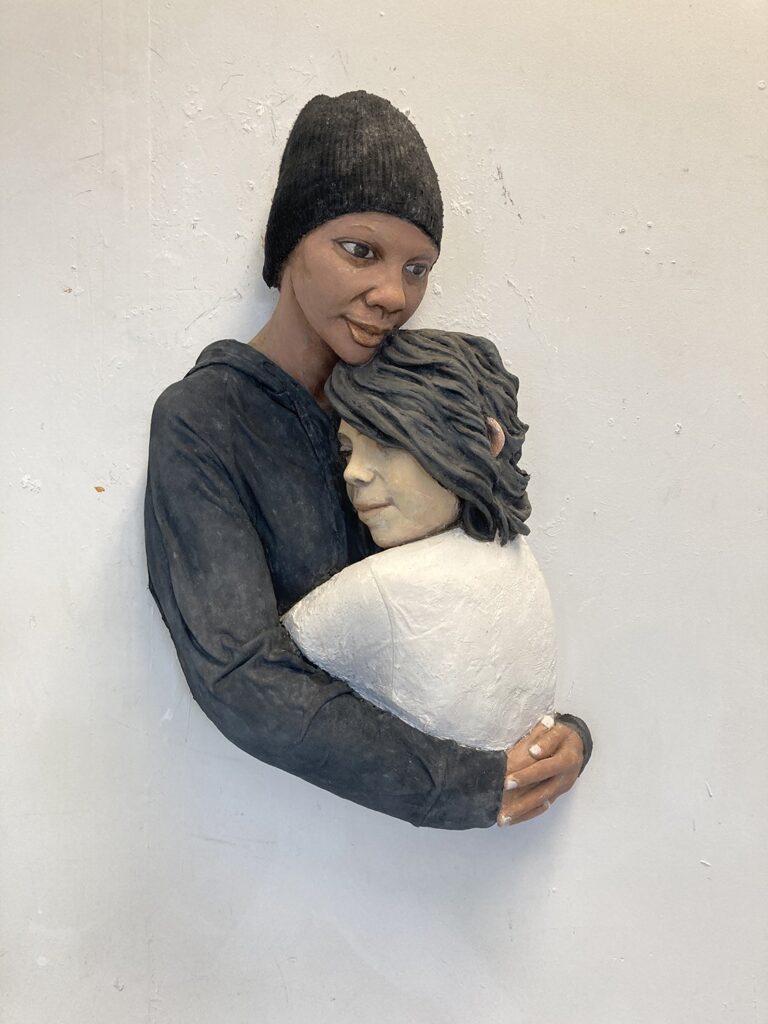 Juanita and Carlos April, by John Ahearn, 2020, acrylic painting over reinforced hydrocal, wool cap, and cloth hoodie
