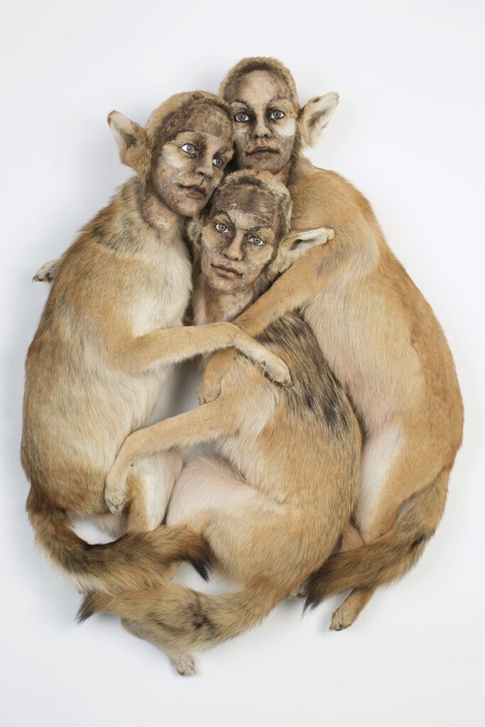 The Sisters' Embrace, by Kate Clark, 2019, clay, pins, thread, and rubber eyes