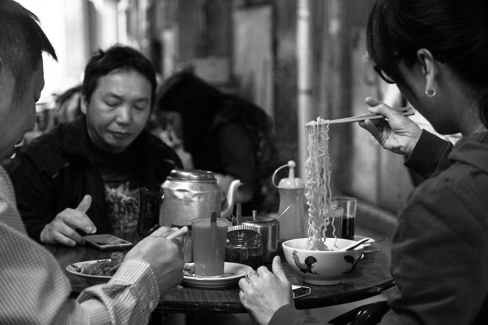 Locals Eating at a Street Café, by Ken Carl, 2013, photograph