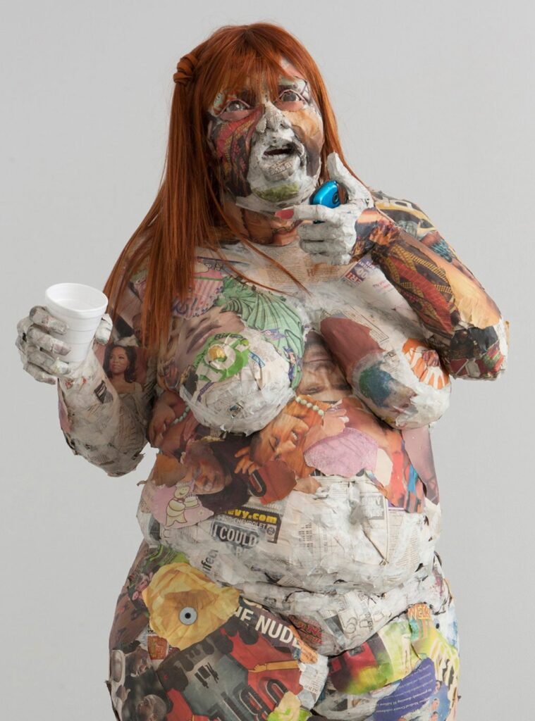 Adora, by Will Kurtz, 2011, Wood, metal wire, newspaper, glue, tape, matte medium, wig, earrings, cell phone and styro