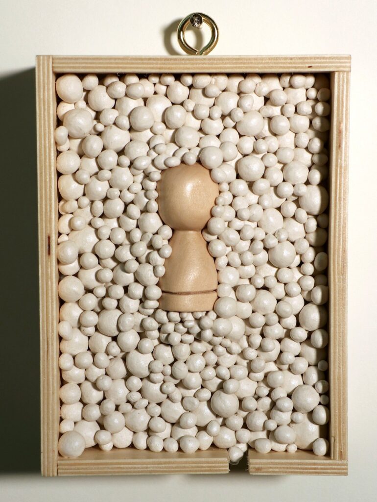 Pawn #2, by Raena Park, 2022, wood and paper clay