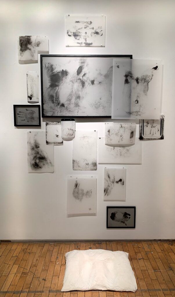 Praying to the "Holy Body, by Spyros Prokopiou, 2019, lithograph installation with plaster pillow, dimensions variable