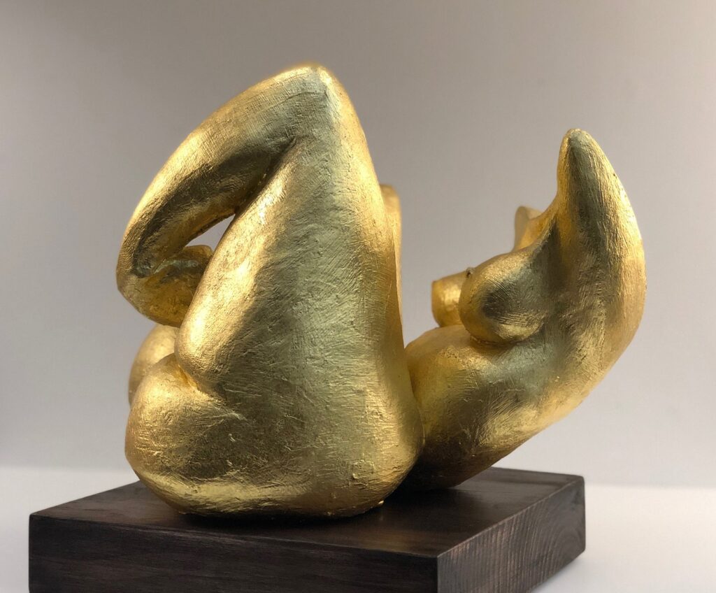 Folded Woman, by Kelly Robert, 2019, gypsum and 22 karat gold leaf