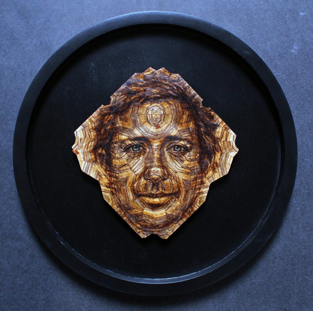 Diego, by Jorge Vasquez, 2023, wood and oil, 10 x 10 x .25 inches, 16 inches diameter framed