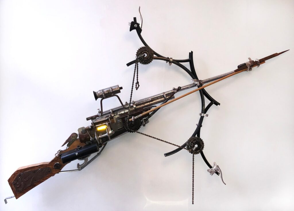 Crossbow, by Moses Tuki, 2015, wood, sheet metal, nails, screws, aluminum cans, cast iron found objects, pipes